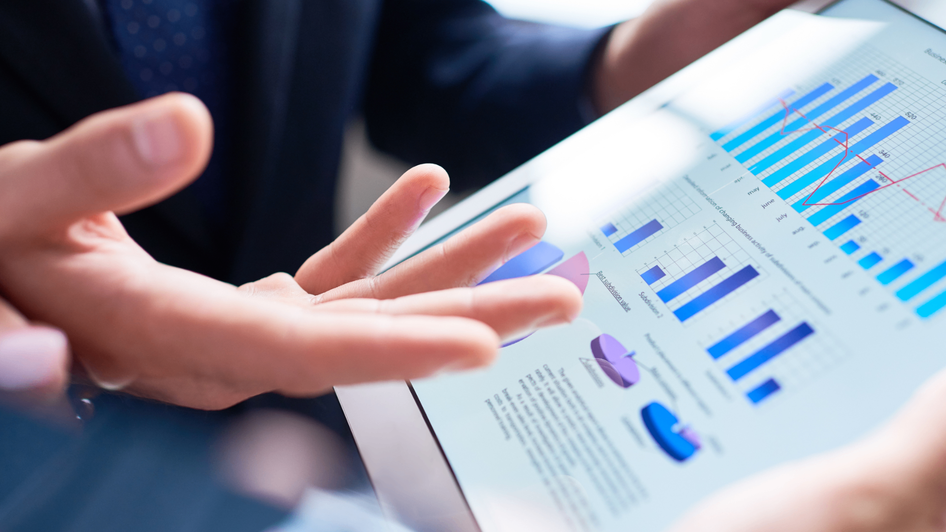 A tablet displaying B2B analytics charts being reviewed in a meeting